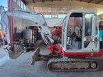 Side view of used 2002 Takeuchi TB135 mini excavator for sale in Rome, Italy