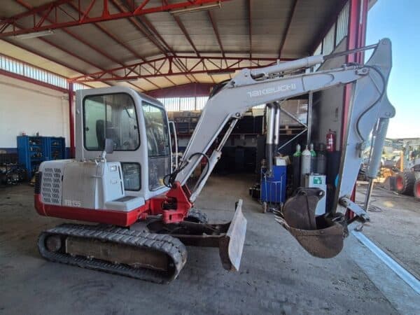 Side view of used 2002 Takeuchi TB135 mini excavator for sale in Rome, Italy
