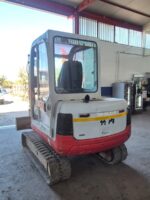 Rear view of used 2002 Takeuchi TB135 mini excavator for sale in Rome, Italy