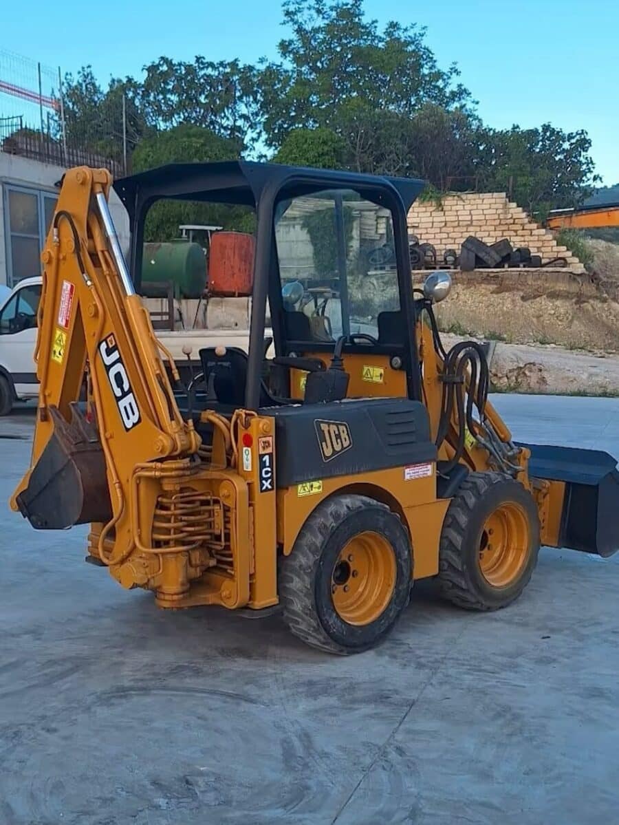 Rear view 2002 JCB 1CX for sale in Foggia, compact and reliable machine with two digging buckets.