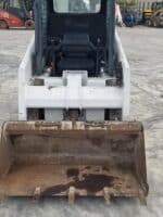 Front view Bobcat 553 with standard bucket included